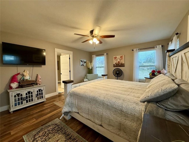 bedroom with multiple windows, ceiling fan, and dark hardwood / wood-style flooring