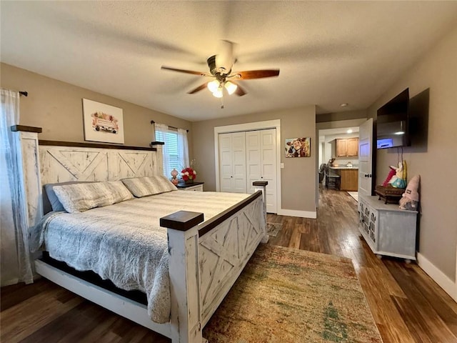 bedroom featuring ceiling fan, dark hardwood / wood-style flooring, a closet, and a textured ceiling