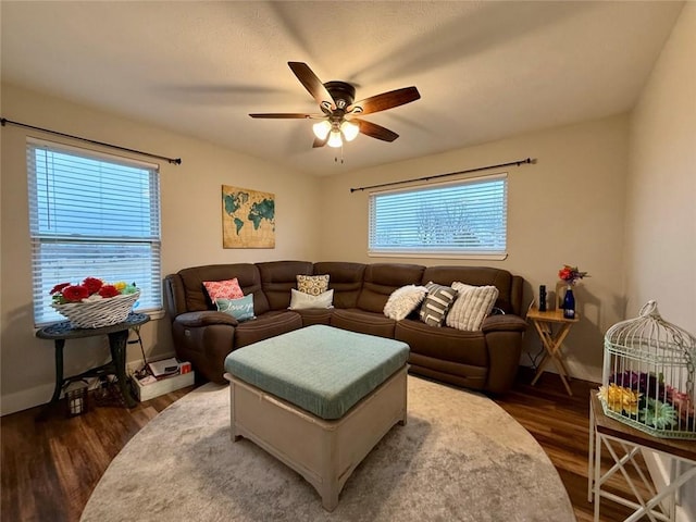 living room featuring ceiling fan, dark hardwood / wood-style flooring, and a wealth of natural light