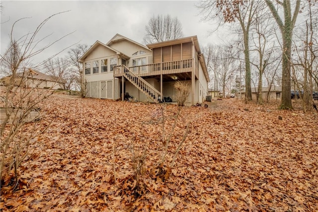 back of house featuring a sunroom and a deck