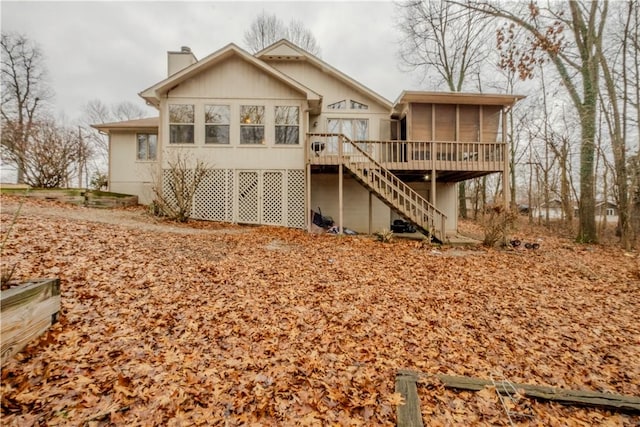 back of property featuring a wooden deck and a sunroom