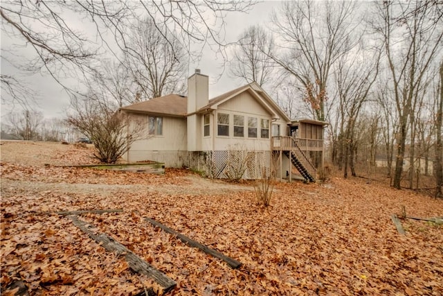2 Quantock Hills Ln, Bella Vista, AR 72715 - rear view of property featuring a sunroom, stairs, and a chimney