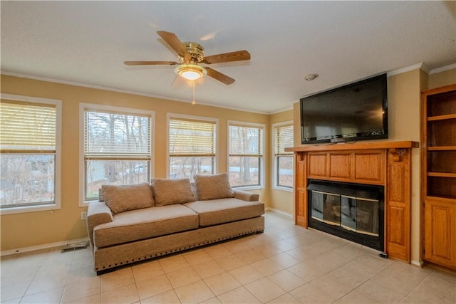 tiled living room featuring crown molding and ceiling fan