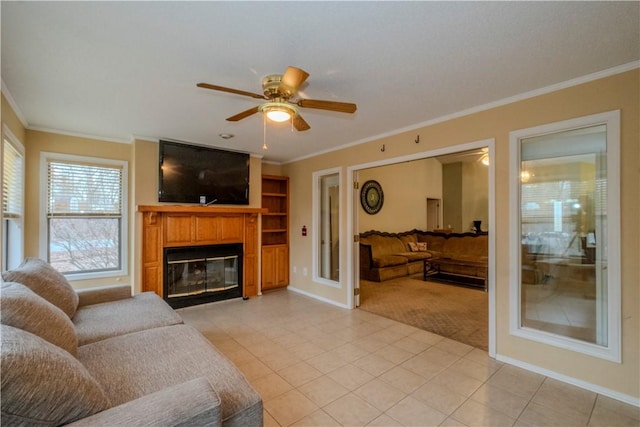 living room with light tile patterned flooring, ornamental molding, and ceiling fan