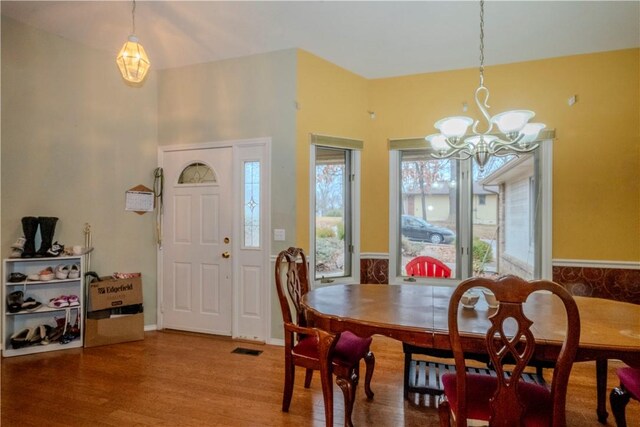 2 Quantock Hills Ln, Bella Vista, AR 72715 - dining room featuring a chandelier and wood finished floors