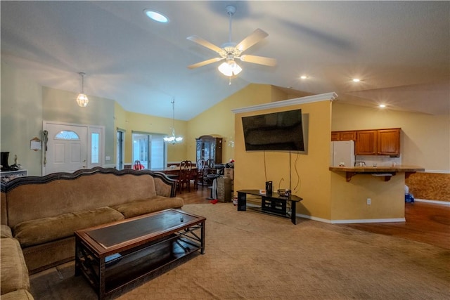 carpeted living room featuring vaulted ceiling and ceiling fan with notable chandelier