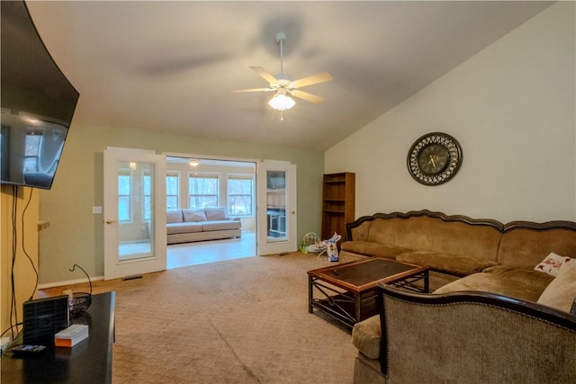 living room featuring ceiling fan, lofted ceiling, and carpet flooring