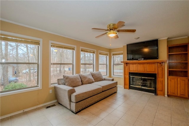 tiled living room featuring crown molding and ceiling fan