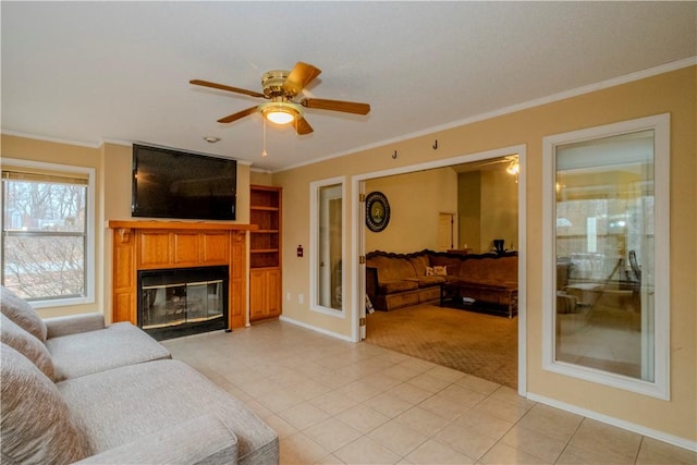 tiled living room with crown molding and ceiling fan