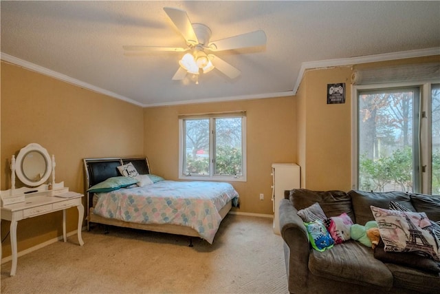 carpeted bedroom featuring ornamental molding and ceiling fan