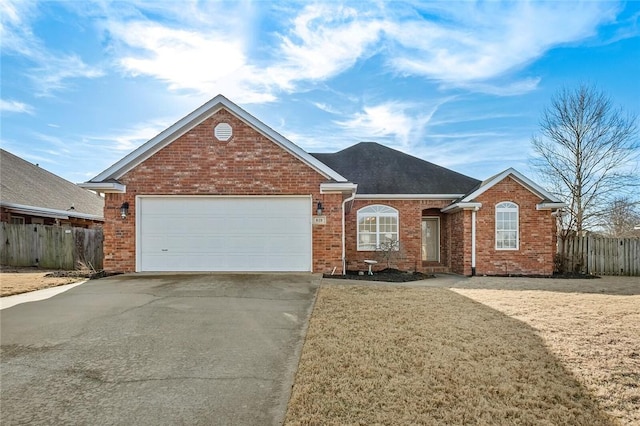 view of front of home with a garage and a front lawn