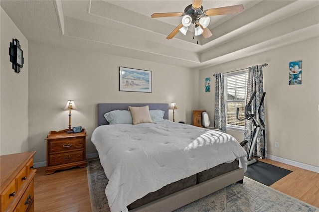 819 Hindman Dr, Prairie Grove, AR 72753 - bedroom featuring a raised ceiling, wood-type flooring, and ceiling fan
