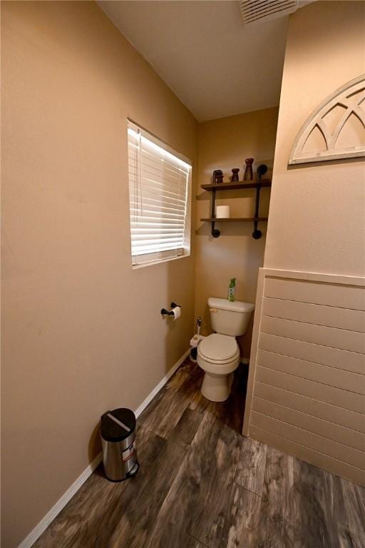 bathroom featuring hardwood / wood-style floors and toilet