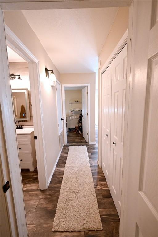 hall featuring sink and dark wood-type flooring