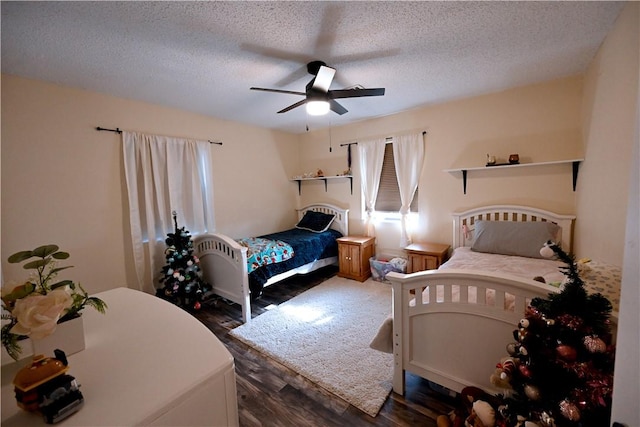 bedroom featuring ceiling fan, dark wood-type flooring, and a textured ceiling