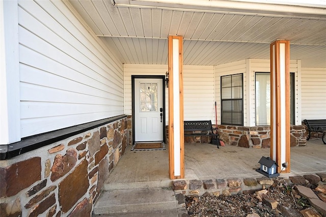 doorway to property featuring covered porch