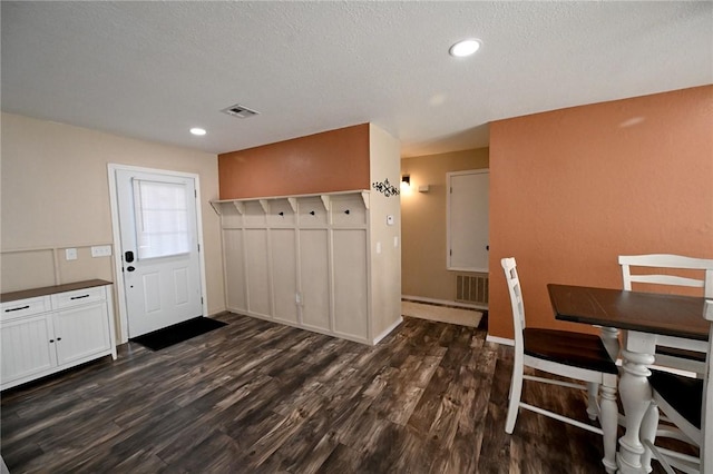 interior space featuring dark hardwood / wood-style flooring and a textured ceiling