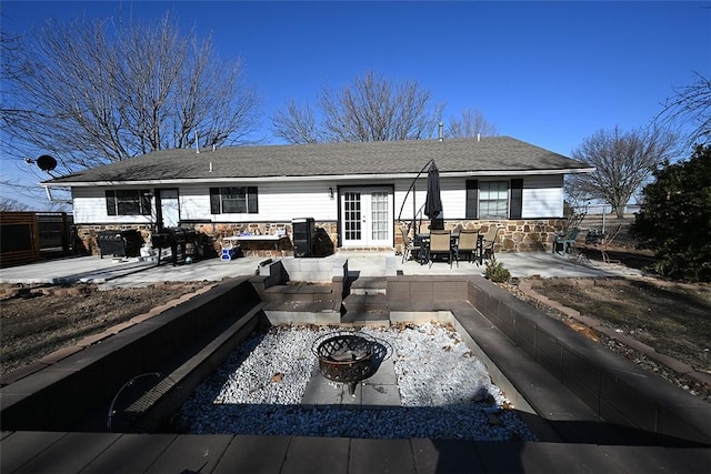 view of front of home featuring an outdoor fire pit and a patio area