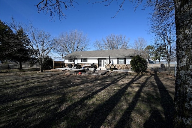 back of property featuring a yard and a patio