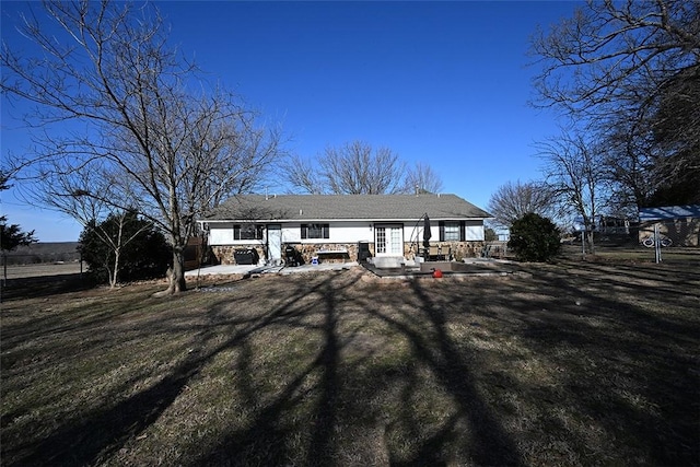 view of front of house featuring a front lawn and a patio area