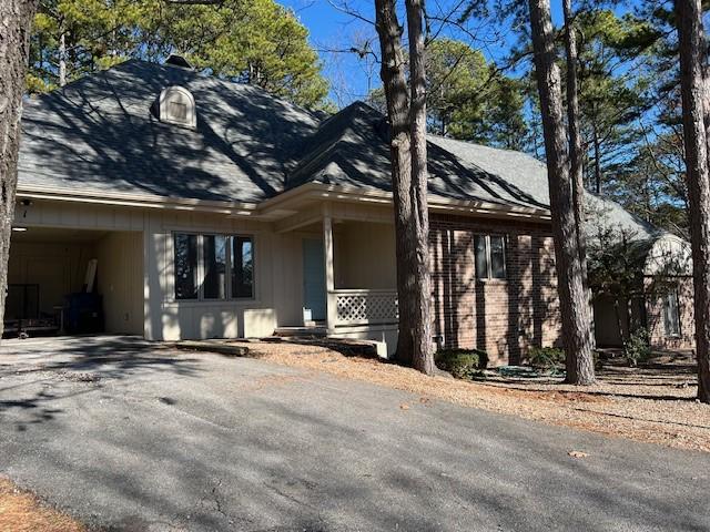 view of side of home with a carport