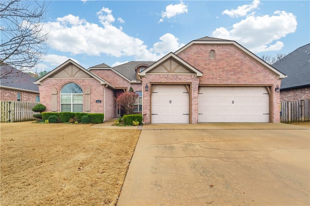 view of front of property featuring a garage and a front yard