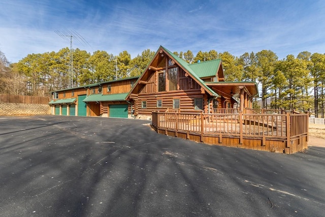 log-style house with a garage