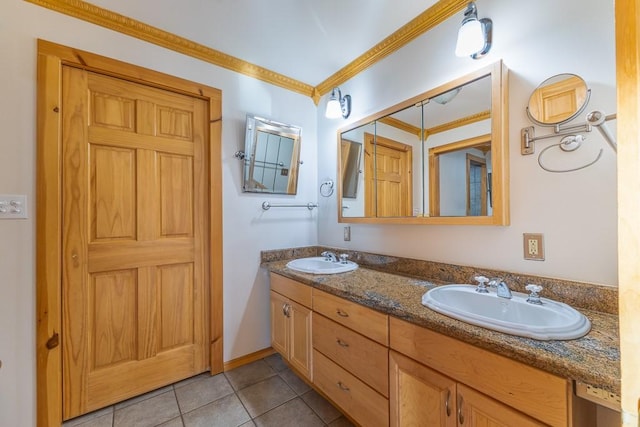 bathroom featuring double vanity, ornamental molding, tile patterned flooring, and a sink