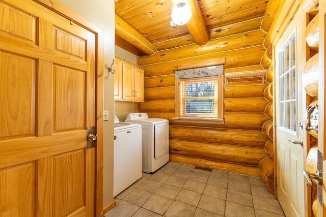 clothes washing area with log walls, cabinet space, washing machine and dryer, light tile patterned flooring, and wooden ceiling