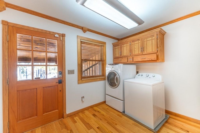 laundry room with light wood-style flooring, separate washer and dryer, baseboards, ornamental molding, and cabinet space