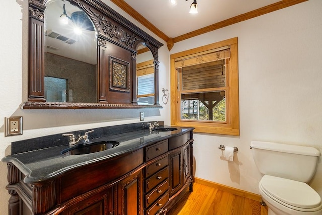 bathroom with visible vents, a sink, toilet, and wood finished floors