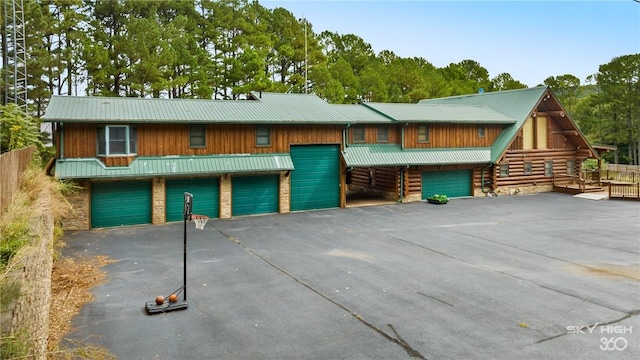 view of front of home featuring aphalt driveway and metal roof