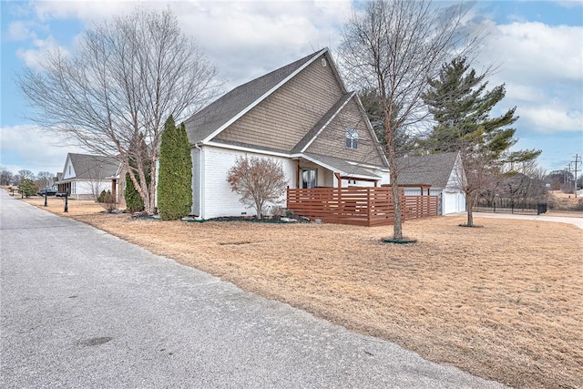 view of property exterior with an outbuilding, a yard, and a garage