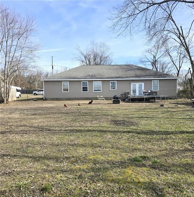 rear view of house featuring french doors and a yard