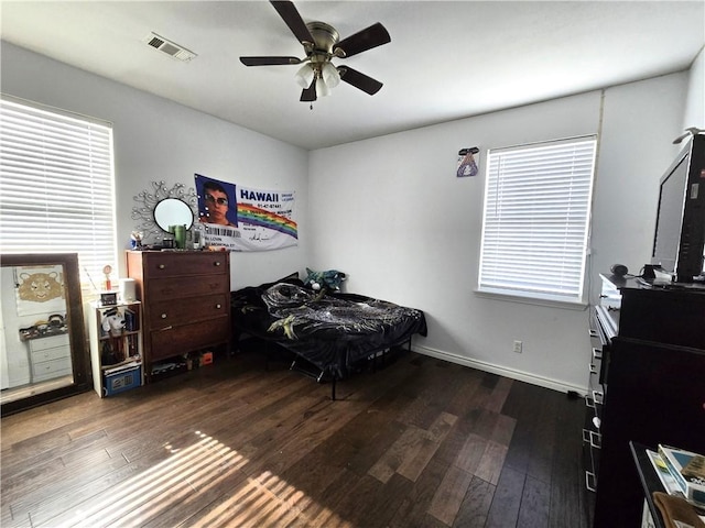 bedroom with ceiling fan and dark hardwood / wood-style floors