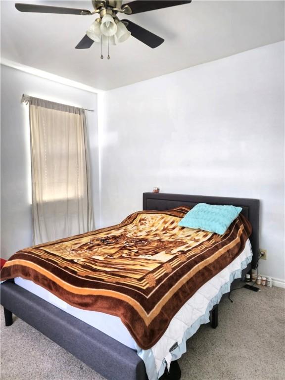 bedroom featuring ceiling fan and carpet flooring