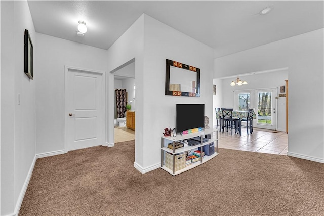 1408 N B St, Rogers, AR 72756 - hallway featuring carpet floors, a chandelier, baseboards, and tile patterned flooring