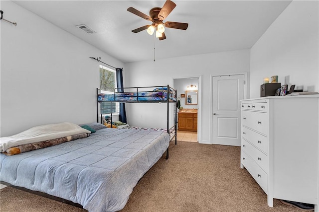 1408 N B St, Rogers, AR 72756 - bedroom with light colored carpet, ceiling fan, and ensuite bathroom