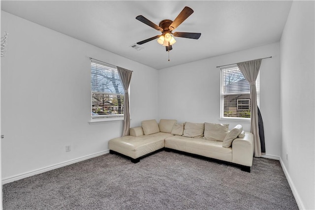 1408 N B St, Rogers, AR 72756 - carpeted living area with plenty of natural light, a ceiling fan, and baseboards