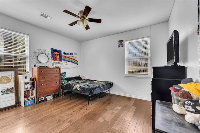 1408 N B St, Rogers, AR 72756 - bedroom featuring wood finished floors, multiple windows, and ceiling fan