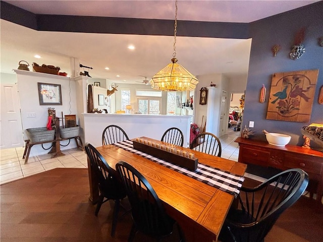 tiled dining space with a notable chandelier