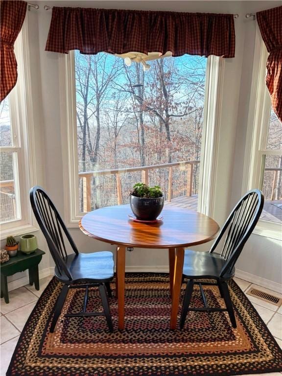 dining room featuring light tile patterned flooring and a wealth of natural light