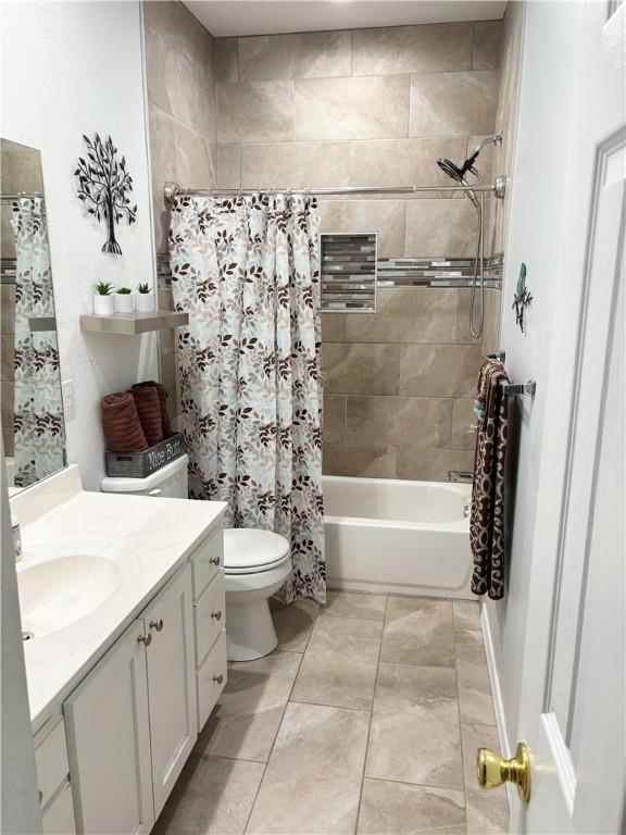 full bathroom featuring vanity, toilet, and shower / bath combo