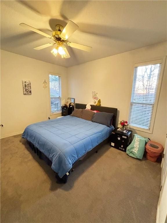 bedroom featuring multiple windows, carpet floors, and ceiling fan