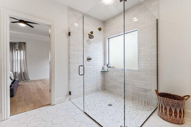 bathroom with ceiling fan, tile patterned flooring, and a shower with door