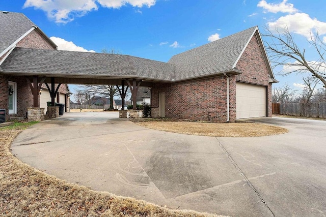 view of property exterior featuring a garage, a carport, and central air condition unit