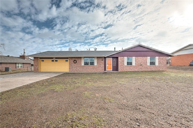 ranch-style home with a garage, cooling unit, and a front yard