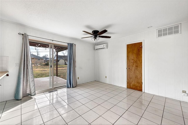913 17th St, Rogers, AR 72758 - empty room featuring a wall mounted air conditioner, a textured ceiling, ceiling fan, and light tile patterned floors