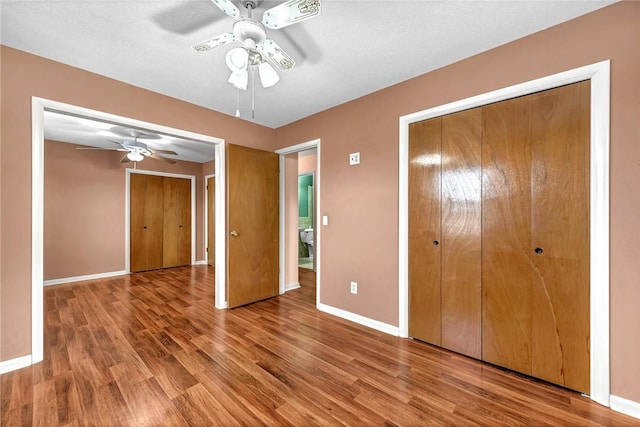 913 17th St, Rogers, AR 72758 - unfurnished bedroom featuring hardwood / wood-style floors, a textured ceiling, and ceiling fan