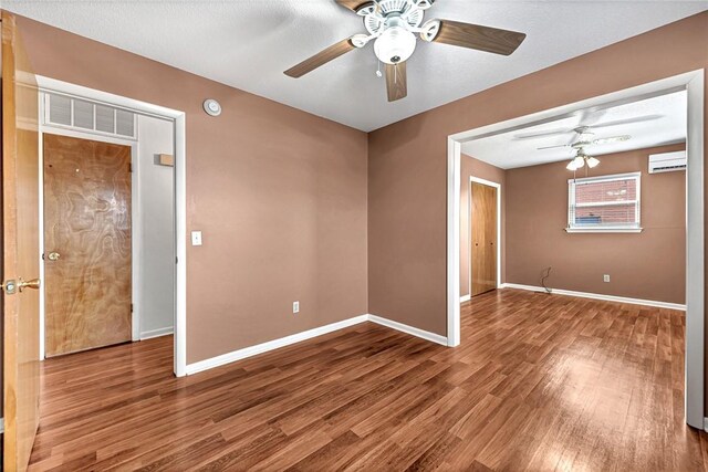 913 17th St, Rogers, AR 72758 - spare room featuring ceiling fan, wood-type flooring, and a wall mounted AC